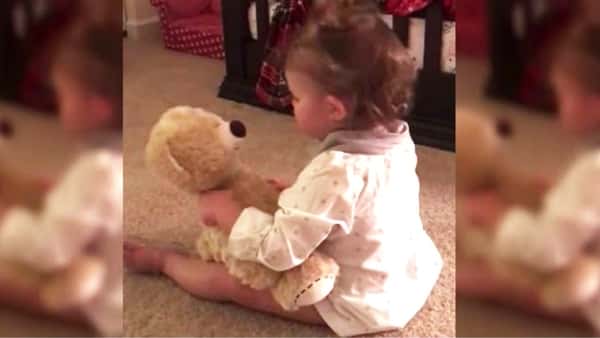 Den lille jenta får en teddybjørn av pappa, men se hva som skjer når hum klemmer på den!