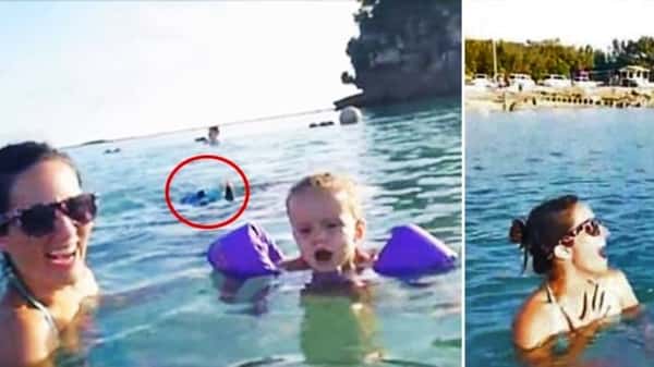 Mor og barn koser seg i vannet mens de sender en videohilsen til far -men følg med på hva som skjer bak dem!